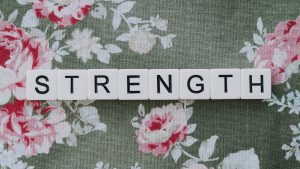 Word, Strength" on a floral fabric background