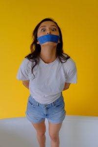 Woman with tape on mouth