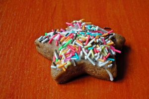 Star-shaped cutout cookie with multi-colored sprinkles