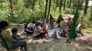 Nature Babies Class at Kreher Nature Preserve gathering in a circle outside A great thing to do with babies in the Auburn-Opelika area!